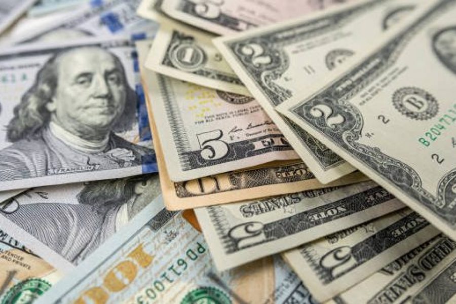 1 2 5 10 100 Different dollar bills in a pile as background. Finance concept